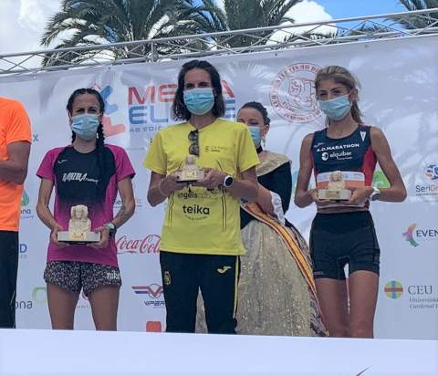 Neus Mas, de amarillo, en el podio de la Mitja Marató d’Elx.